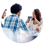 3 office workers collaborating around a table.