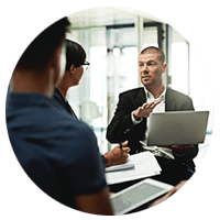 Business manager discussing strategy in meeting with laptop computer