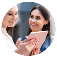 Two businesswomen with tablet device outside