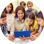 Teacher looking at tablet, surrounded by students.