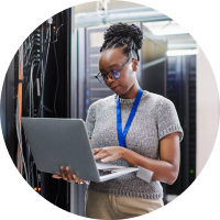 woman with laptop in server room