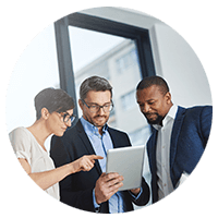 Three people looking at a tablet