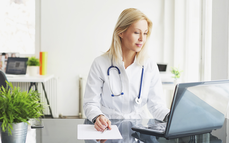 Female doctor using laptop