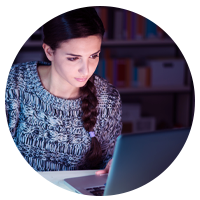 Student studying at night on laptop