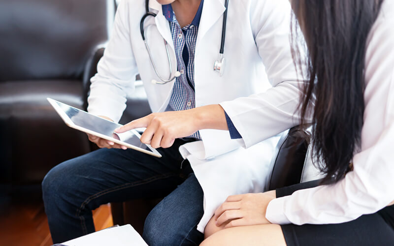 Doctor and nurse on tablet devices in hospital