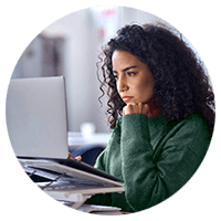 Woman with curly hair working using her laptop