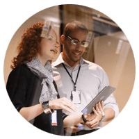 Business man and woman looking over tablet computer