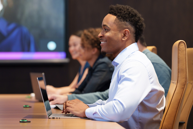 Smiling Insight employee in conference room meeting