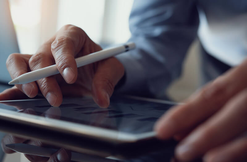 Close up of tablet computer and stylus in use