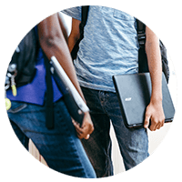 Students holding notebook computers powered by Intel while talking at their locker