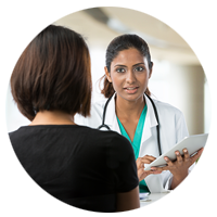 Doctor using tablet computer with patient