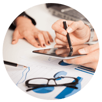 Man checking his phone and studying finance displays.