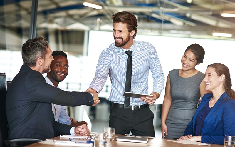 Businessman closing the deal with partners in meeting