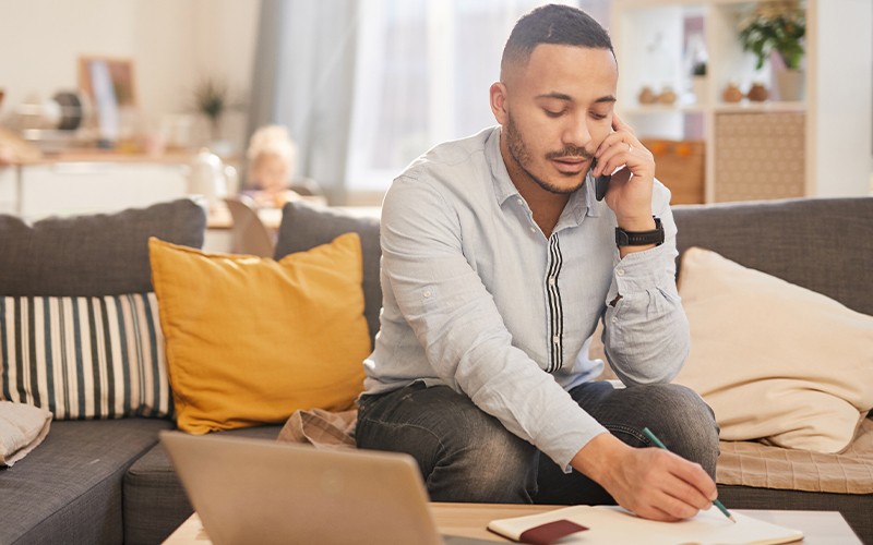 Man talking on the phone on couch