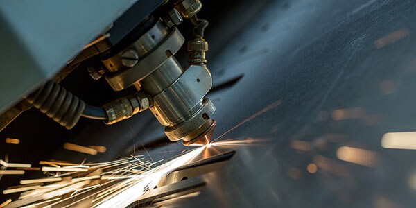 Close up of machine laser cutting metal