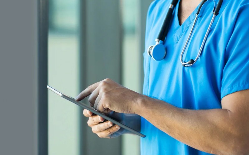 A doctor working and using his tablet