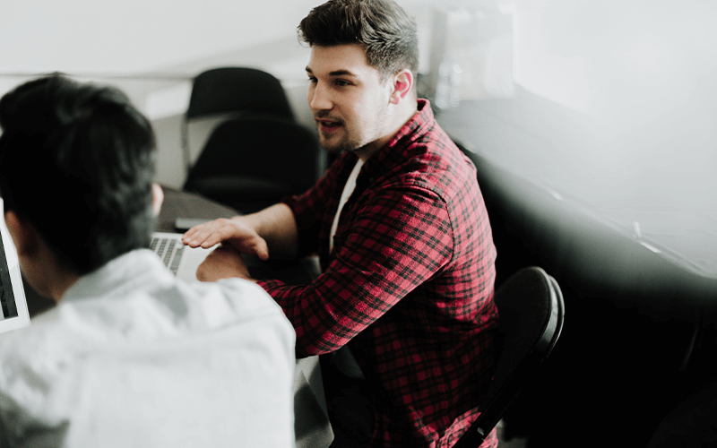 Two men working on a computer 