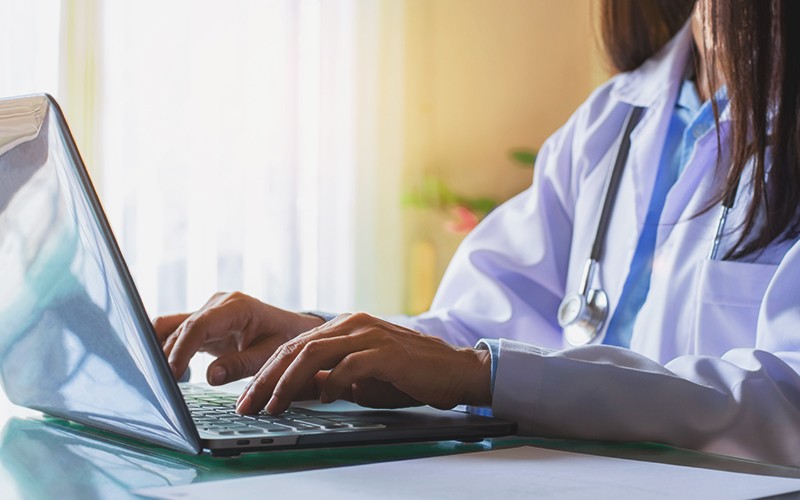 Female doctor using laptop