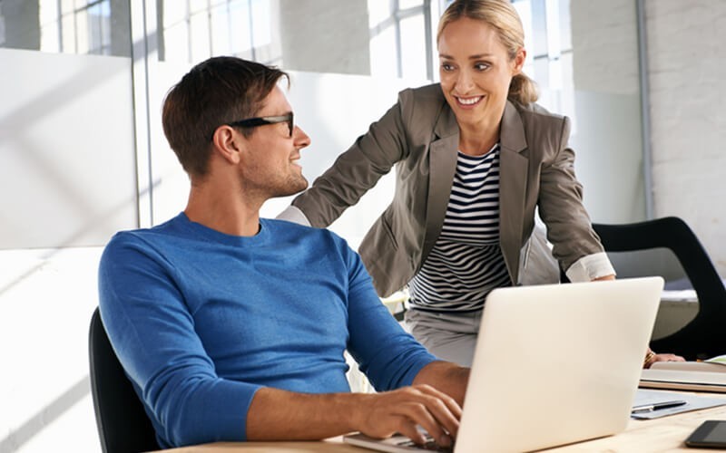 Man and woman working together on a laptop