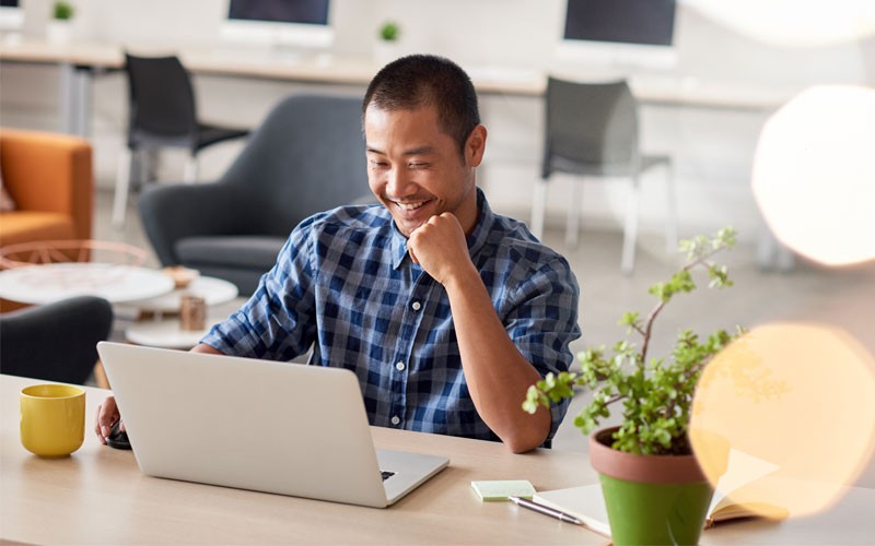 Man working at desk on laptop