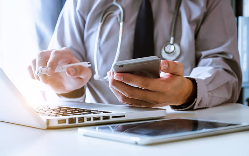 A doctor working in front of his laptop