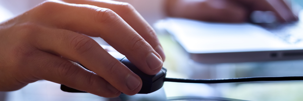 View of hands on a computer mouse