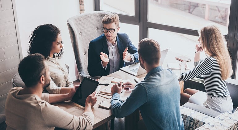 A group of business people discussing their work