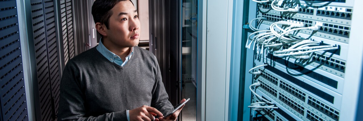 Young businessman working in a server room