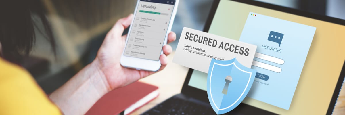 A girl is looking at her phone while it downloads a file. Her laptop is on the table in front of her with a login page. Graphics are displayed showing the phrase "secured access" with a shield and lock icon.