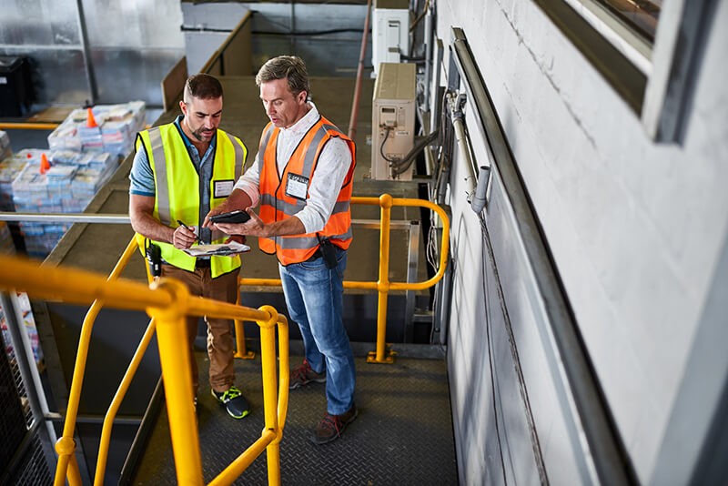 Manufacturing professionals reading ebook