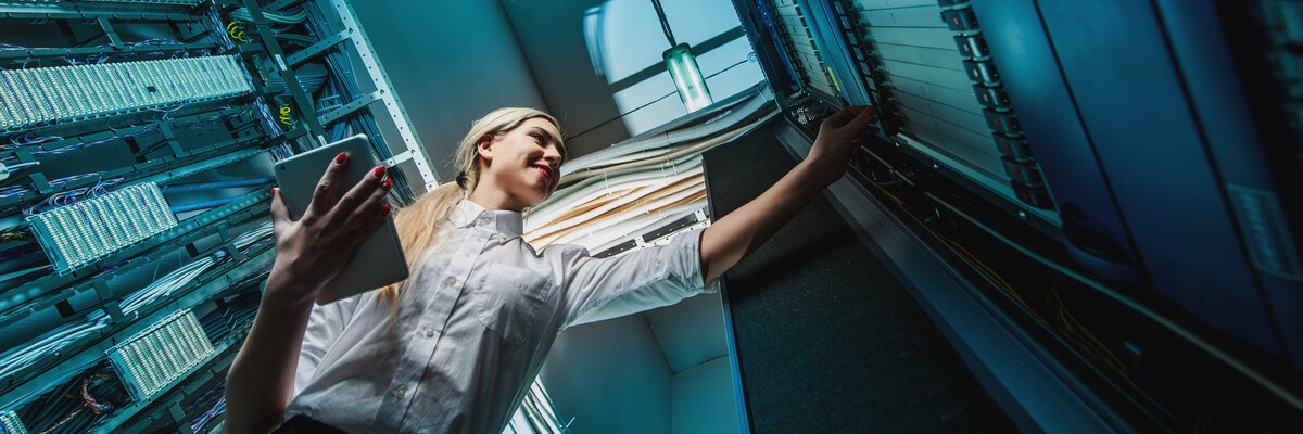 Young engineer businesswoman in server room