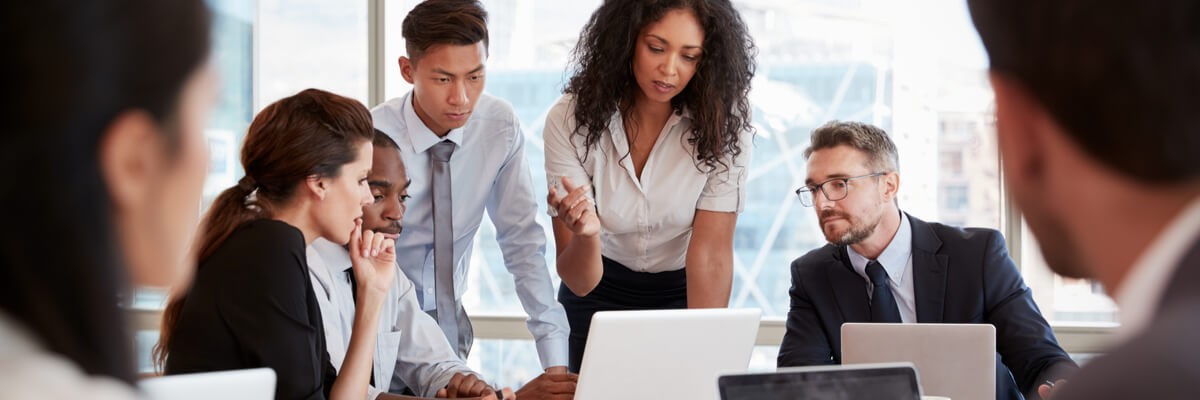 A group of business people meeting around a table in an office