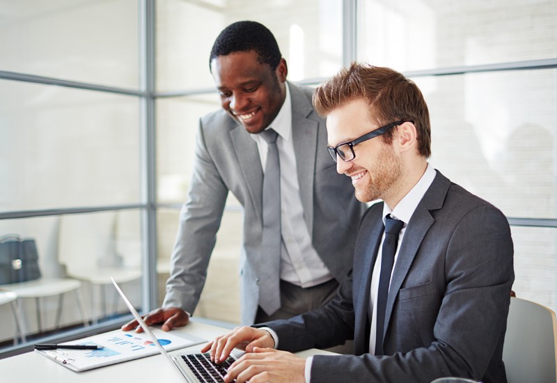 Smiling businesswoman uses tablet device