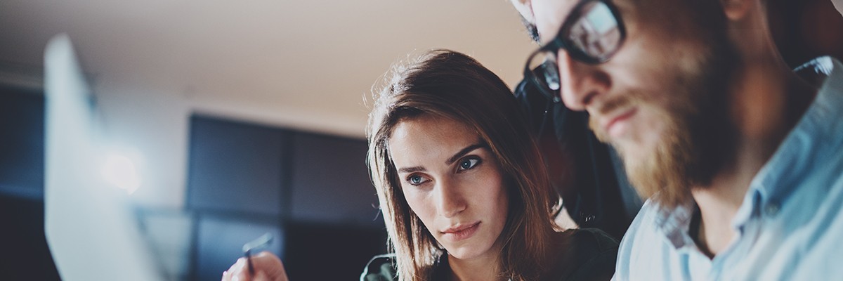 Woman looks at a computer screen.