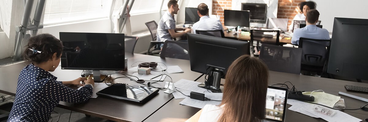 Business room filled with people working on devices.