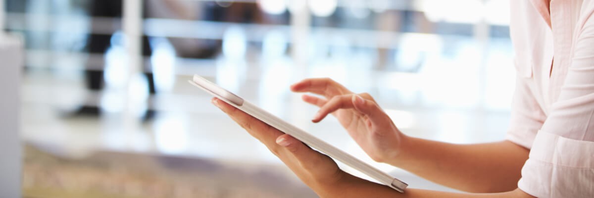 Portrait of smiling woman in office with tablet