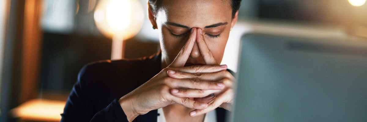 Stressed businesswoman sitting in front of her computer