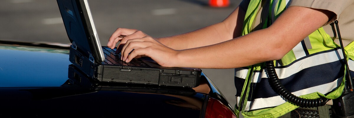 Police using laptop device in field