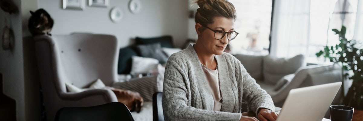 Woman working from home on laptop computer