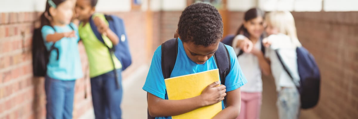 Young boy being bullied by peers