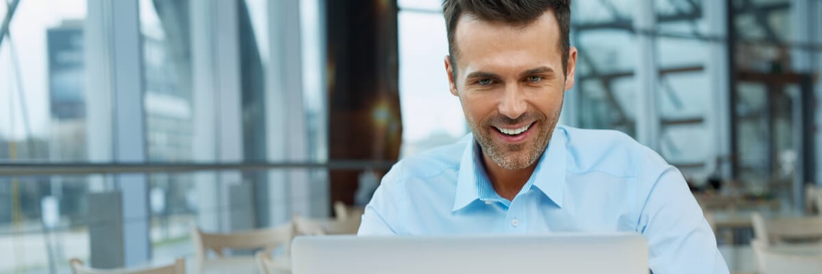 Business man working on laptop outside