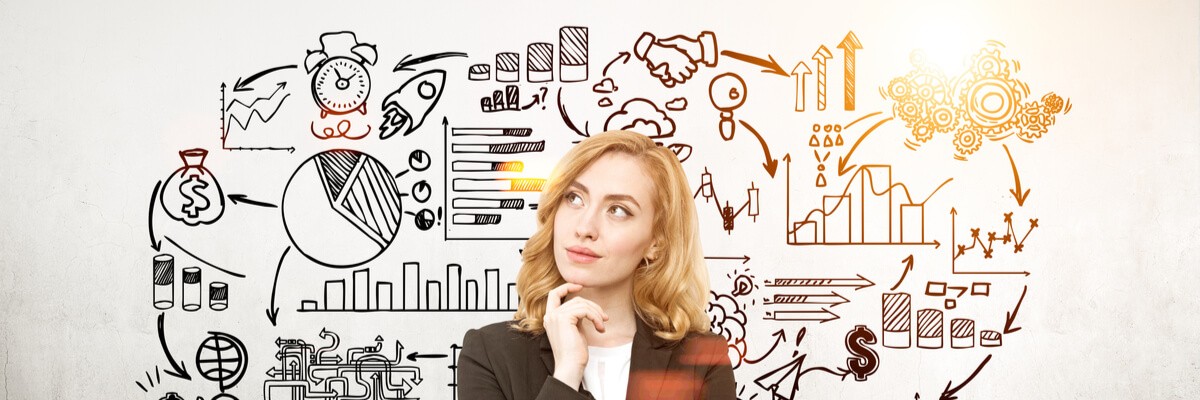 Woman looking up at a bunch of ideas drawn out on the wall.