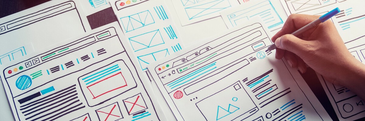 UX/UI designer sketching out lo-fi wireframes for an application development framework during a  design studio session