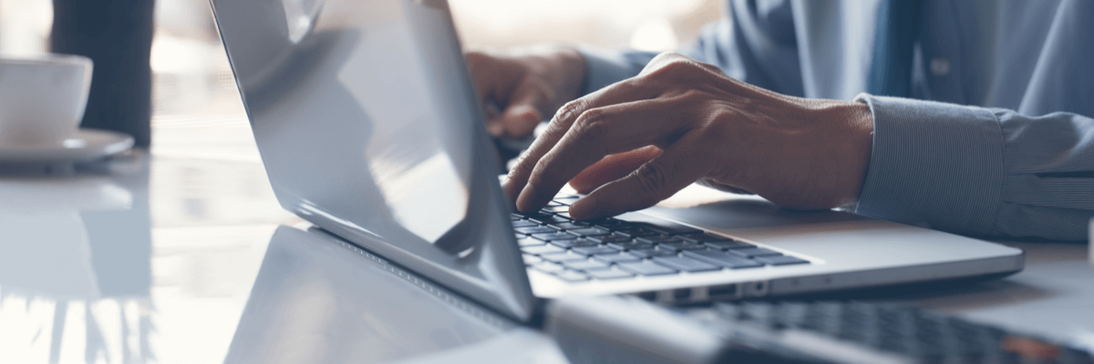 Hands typing on laptop keyboards