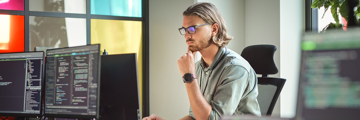 IT dev working on laptop