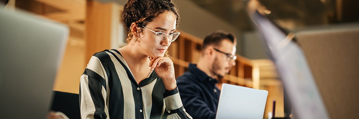 Woman working on computer in open office