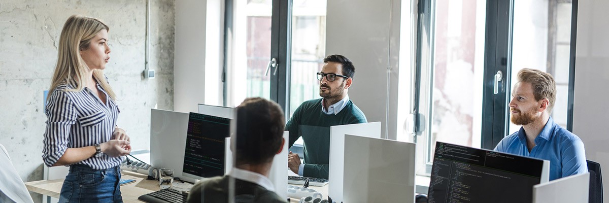 Workers in open office collaborating cover