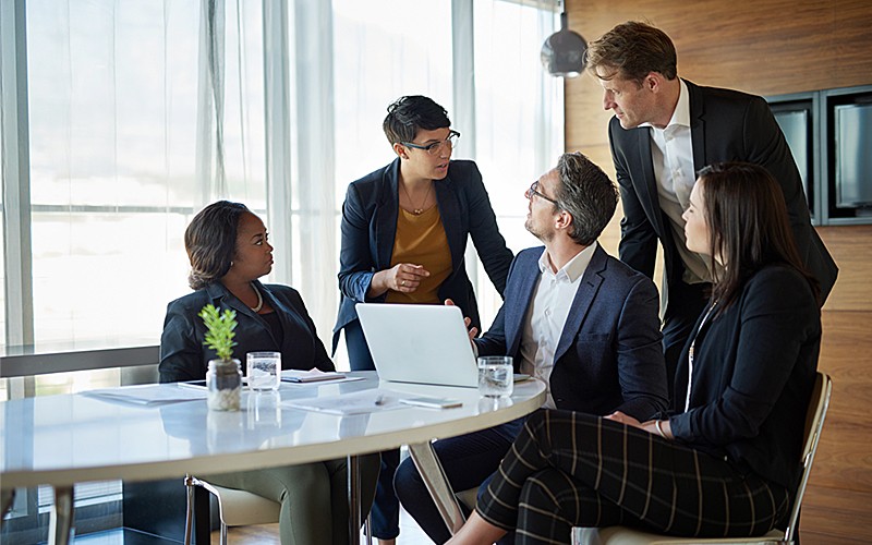 Business professional reading whitepaper off of tablet computer