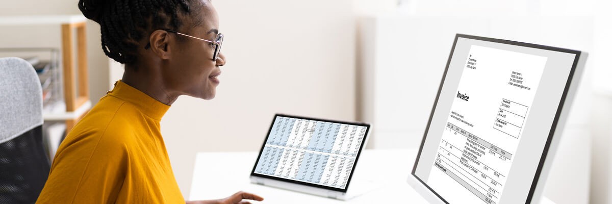 Accountant on computer looking at data