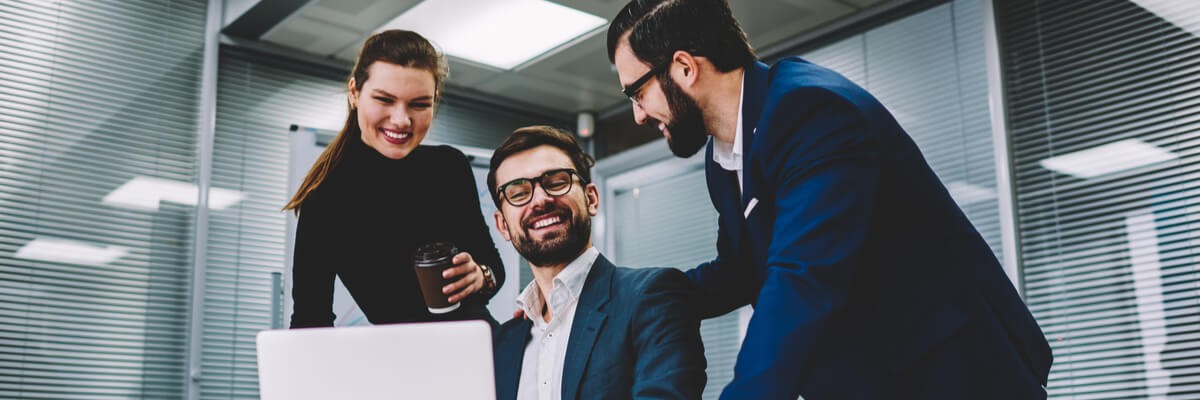 Coworkers collaborating and smiling